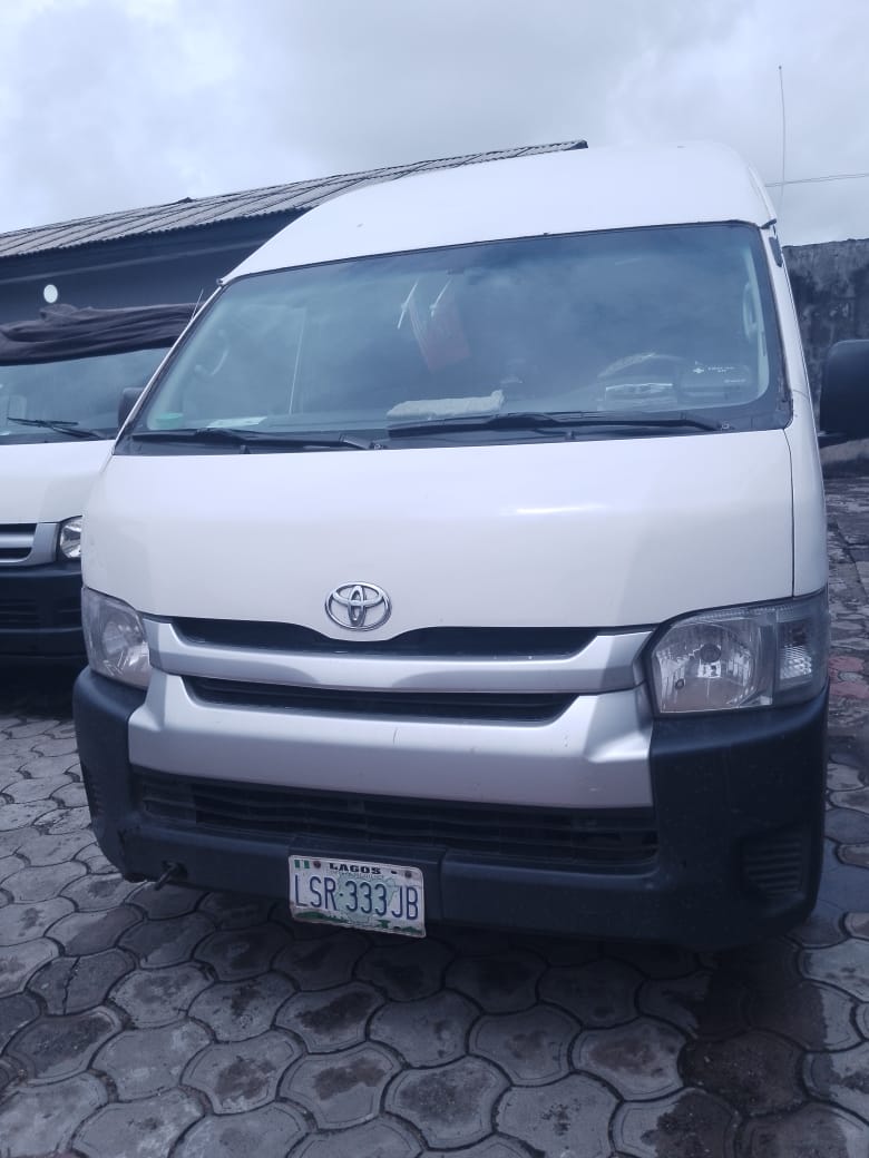 White Toyota Hiace bus, front view