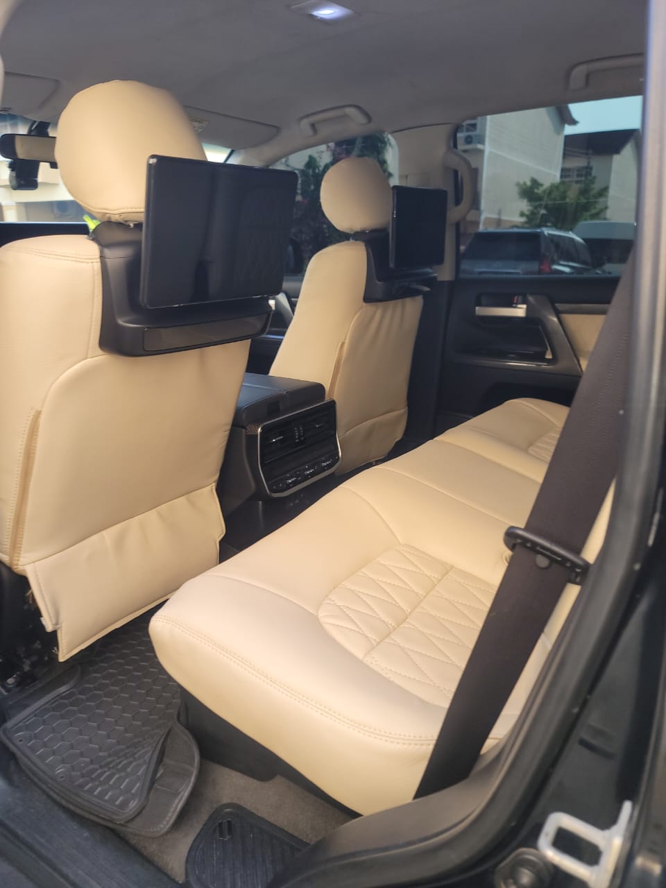 Cream leather rear seats with dual headrest entertainment screens
